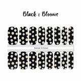 White daisies on a black background nail wrap nail design. 
