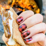 Traditional red and black buffalo plaid nail wrap nail design.