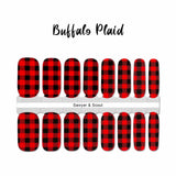 Traditional red and black buffalo plaid nail wrap nail design. 