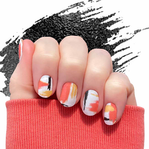 Black and orange brushed art style on white nail wrap nail design