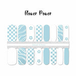 Light blue and white combination of checkerboard, flower, and curvy lines nail wrap nail design