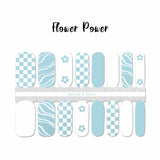 Light blue and white combination of checkerboard, flower, and curvy lines nail wrap nail design