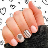 Pink, white and black lines with a heart nail wrap nail design