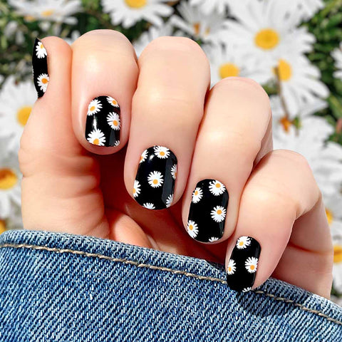 White daisies on a black background nail wrap nail design. 