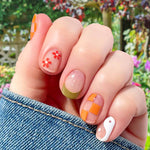 Orange checkerboard, red daisies, white yin yang curves and green French tip