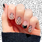 Combo of black daisies on clear and black French tips nail wrap nail design