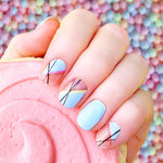 Baby blue slant on clear with black thin lines and  baby blue accent nail wrap nail design