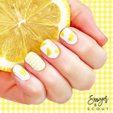 Yellow lemon wedges on white and thin yellow stripes on white nail wrap nail design