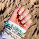 White curves and white curvy lines on transparent nail wrap nail design