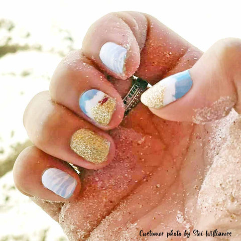 Blue and gold waves with a solid gold glitter accent and small red crab nail wrap nail designs