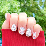 Small red and pink rainbows with black spots on white accents nail wrap nail design