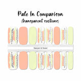 Combination of solid peach and solid pale green with accent nails that include strokes of peach, pale green and white with black dots nail wrap nail design
