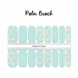 Combination of light aqua palm fronds on a peach background with solid aqua nail accents wrap nail design
