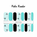 Combination of solid light blue, solid black and white with thin blue stripes overlayed with small black palm trees nail wrap nail design