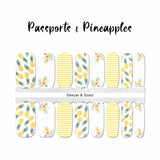 White nail wraps overlayed with a combination of pineapples, yellow flowers and yellow stripe overlays nail wrap nail design