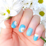 White daisies on blue with white stripes on blue accents nail wrap nail design.  
