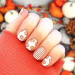 Pumpkins on white and orange stripes on white nail wrap nail design.  