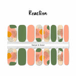 Solid green, solid peach and a mix of green, peach, black spots in artistic patterns accents nail wrap nail design.  
