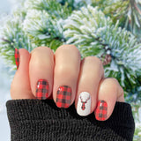 Full red buffalo plaid with red buffalo plaid deer head silhouette on white accents and one white deer head silhouette on black accent nail wrap nail design.  