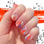 Paint splotches of red, purple, pink and gold with some transparent sections nail wrap nail design.  