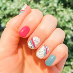 Combination of pink, blue and black spots on white nail wrap nail design.  