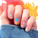 Mix of random blue, yellow, green, red and black spots on white graphics on a transparent background nail wrap nail design.  