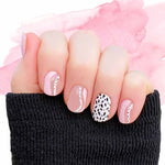 Combination solid pink, pink curves on clear and black spots on white accents nail wrap nail design.  