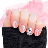 Combination solid pink, pink curves on clear and black spots on white accents nail wrap nail design.  