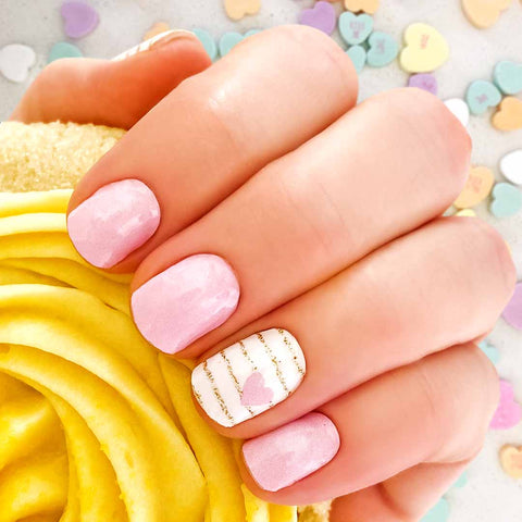 Combination of solid pink nail wraps and gold glitter stripes on white with little pink hearts accents nail wrap nail design.  