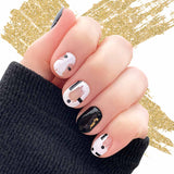 Combination of solid black with gold accents and white on transparent with black rectangles  and dots nail wrap nail design.  