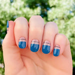 Dark blue tips with a thin black line on clear near the cuticle nail wrap nail design.  