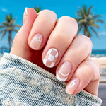 A mix of white smiley face, lightning bolt, french tip and checkerboard nail wrap nail design.  