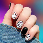 Solid black with multi colored leopard spots with black outlines on white nail wrap nail design.  