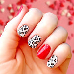 Solid red with pink and black leopard spots on white nail wrap nail design.  