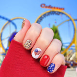 Combination of solid blue with white stars, solid red, light brown leopard print, and american flag hearts on white nail wrap nail design.  