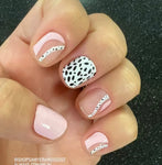 Combination solid pink, pink curves on clear and black spots on white accents nail wrap nail design.  